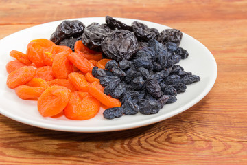 Traditional dried fruits on dish closeup at selective focus