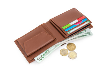 Brown leather wallet with money and coins beside