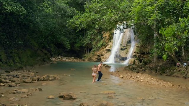 Couple Hiking on a Waterfall