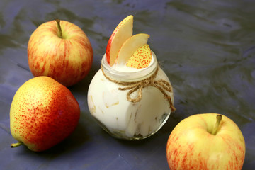 Food. Milk product. Creamy yogurt in a jar with pieces of fresh juicy fruit, pears and apples for a healthy diet.