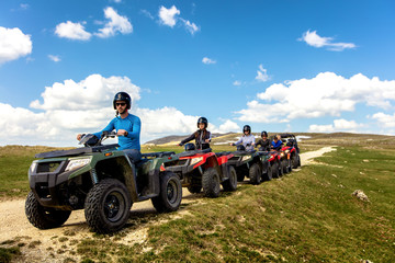 Friends driving off-road with quad bike or ATV and UTV vehicles - obrazy, fototapety, plakaty