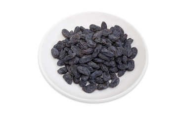 Raisins on the saucer on a white background
