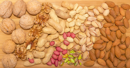 Top view of the various nuts on a wooden surface