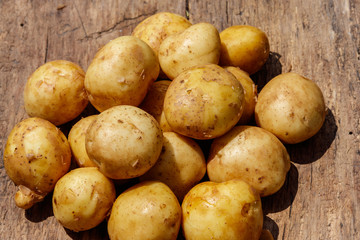 New potatoes on rustic wooden table