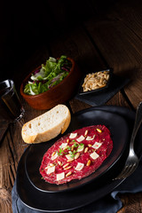 Carpaccio of beef with pine nuts, colorful pepper and Parmesan cheese