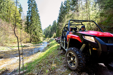 A tour group travels on ATVs and UTVs on the mountains © FS-Stock