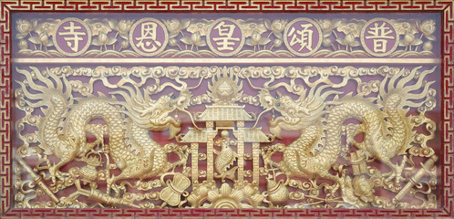 Fototapeta na wymiar Traditional golden chinese dragon wood carved with mirror reflect.