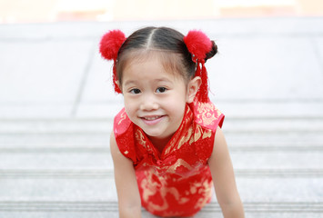 Little asian girl in cheongsam on traditional chinese new year festival.