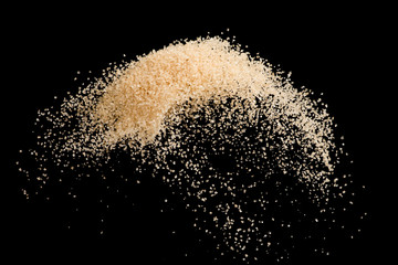 Brown sugar flying explosion splash isolated on black background  ,throwing freeze stop motion element food and drink object design