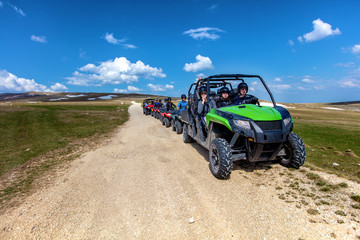 Friends driving off-road with quad bike or ATV and UTV vehicles © FS-Stock