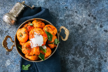 Traditional Turkish food - fellah koftes, polpettes from bulgur and semolina in tomato sauce with parsley and ayran. Middle eastern food concept.