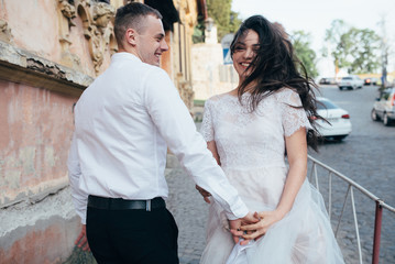 A young, sympathetic couple walks through the streets of the city.