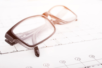 Architectural project and  glasses. Construction background.