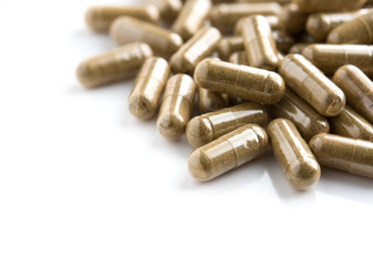 Herbal medicine powder in capsule on white background