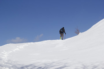 Naklejka na ściany i meble hikers walking in the snow in mountain