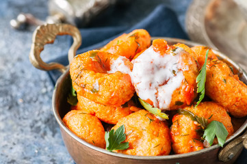 Traditional Turkish food - fellah koftes, polpettes from bulgur and semolina in tomato sauce with parsley and ayran. Middle eastern food concept.