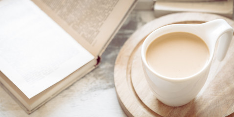 a cup of coffee with books