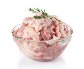 Small piece raw chicken in glass bowl isolated on white background