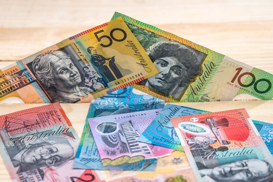 Pile of australian dollars on wooden desk