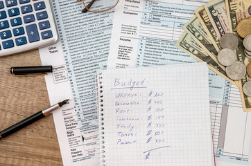 home budget with tax form, money and calculator