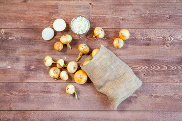 fresh onions on a wooden table background. wallpaper for grocery shopping and cooking food concept. top view, flat lay