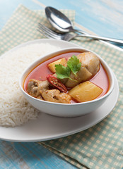 Spicy Muslim chicken curry,Thai massaman curry in a bowl and rice on wood background