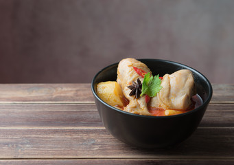 Spicy Muslim chicken curry,Thai massaman curry in a bowl on wood background