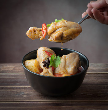 Spicy Muslim chicken curry,Thai massaman curry in a bowl on wood background