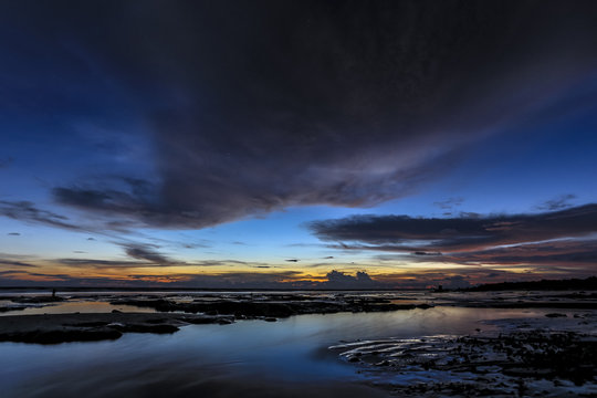 Beautiful Sekinchan Malaysia seaside beach view at sunset with dramatic cloud and reflection.