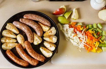 Raw meat sausages with pears and vegitables ready to cook.