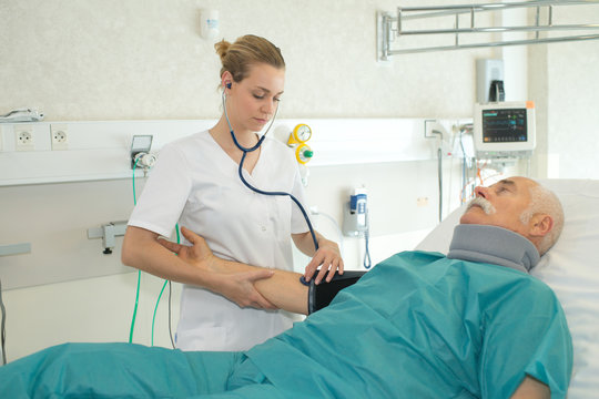 nurse doing a medical examination on senior patient