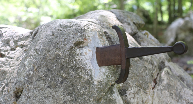Excalibur sword in the stone in the forest