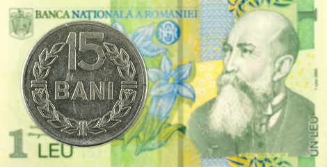 Fototapeta na wymiar 15 romanian bani coin against 1 romanian leu bank note
