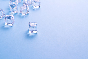 Ice cubes on a light blue background