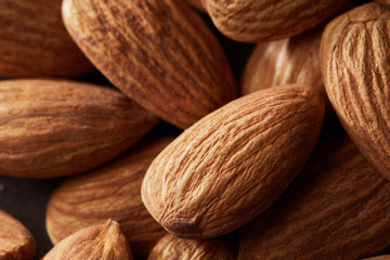 Background of big raw peeled almonds macro shot