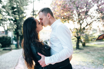 A young, sympathetic couple walks through the streets of the city
