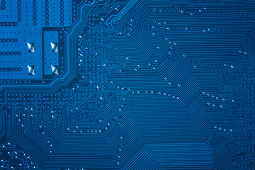 Close up of blue circuit computer motherboard. Computer technology background.