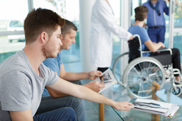 men waiting in the lobby of a hospital