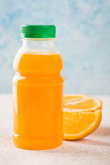 Delicious orange lemonade in a plastic bottle.
