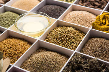 Indian Spices in white wooden box with cells, selective focus.