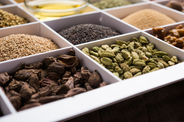Indian Spices in white wooden box with cells, selective focus.