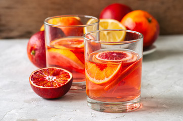 Citrus infused water with slices of fruits. Seasonal beverages concept