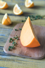 Mimolette cheese on the wooden board