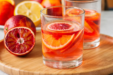 Citrus infused water with slices of fruits. Seasonal beverages concept