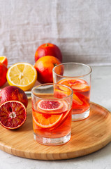 Citrus infused water with slices of fruits. Seasonal beverages concept