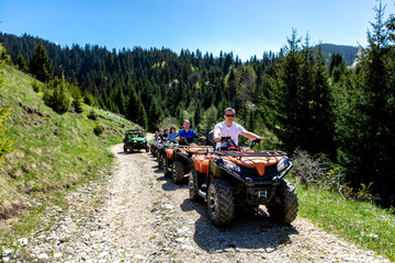 A tour group travels on ATVs and UTVs on the mountains