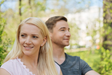 Fototapeta premium Young couple outdoors in a garden