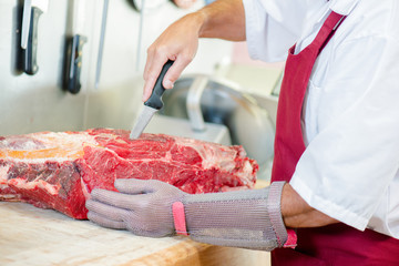Butcher cutting meat