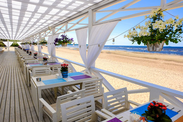 Restaurant by the sea. Background. Nature. Water. Beach sand. Terrace cafe with canopy. Decorative element. Interior decoration. Restaurant by the sea. Background. Nature. Water. Beach sand.