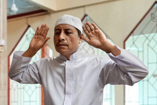 Old muslim man praying in mosque